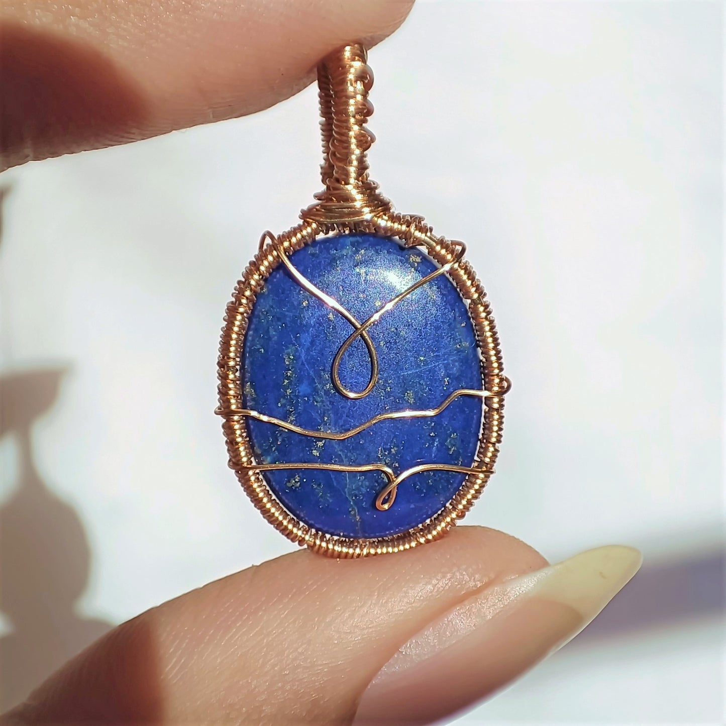 Hand woven lapis lazuli pendant